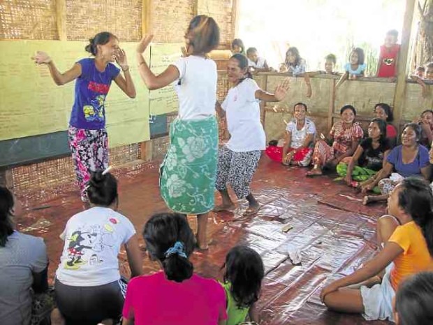 Bajau elders perform the traditional “igal-igal” dance during a workshop.
