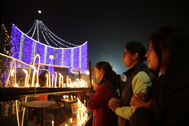 Indians light candles and pray at the decorated Saint Joseph's Cathedral on the Christmas eve in Lucknow, India, Saturday, Dec. 24, 2016. Though the Hindus and Muslims comprise majority of the population in India, Christmas is a national holiday celebrated with much fanfare. (AP Photo/Rajesh Kumar Singh)