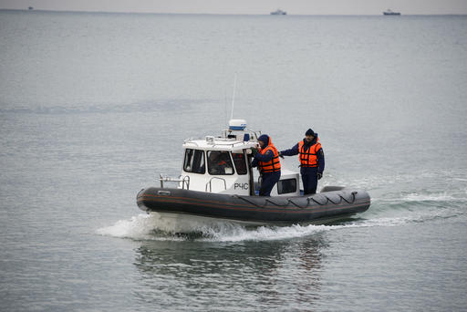 Ministry of Emergency Situations employees search for bodies by a boat in the Black Sea, off Sochi, Russia, Monday, Dec. 26, 2016. All 84 passengers and eight crew members on the Russian military's Tu-154 plane are believed to have died Sunday morning when it crashed two minutes after taking off from the southern Russian city of Sochi. (AP Photo/Viktor Klyushin)