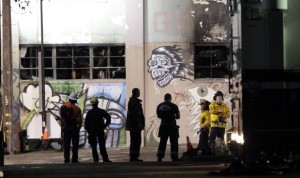 Emergency personnel in front of burned Oakland warehouse