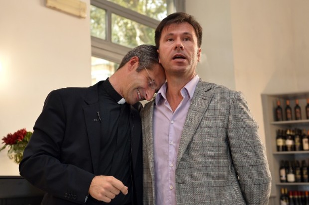 Father Krysztof Olaf Charamsa (L), who works for a Vatican office, gives a press conference with his partner Edouard to reveal his homosexuality on October 3, 2015 in Rome. The priest said he wanted to challenge what he termed the Church's "paranoia" with regard to sexual minorities, claiming the Catholic clergy was largely made up of intensely homophobic homosexuals. The Vatican condemned the coming out of a Polish priest on the eve of a major synod as a "very serious and irresponsible," act which meant he would be stripped of his responsibilities in the Church's hierarchy. In a statement, a spokesman said Krzystof Charamsa would not be able to continue in his senior position in the Vatican and that his future as a priest would be decided by his local bishop.  AFP PHOTO / TIZIANA FABI / AFP PHOTO / TIZIANA FABI