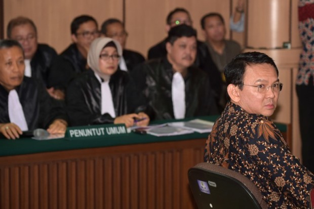 Jakarta's Christian governor Basuki Tjahaja Purnama (R), better known by his nickname Ahok, looks on in a courtroom at the North Jakarta court for his trial for blasphemy in Jakarta on December 20, 2016. Jakarta's Christian governor Purnama returned to court on December 20 to fight controversial allegations of insulting the Koran that could see him jailed under tough blasphemy laws in the world's largest Muslim-majority country. / AFP PHOTO / POOL / Adek BERRY