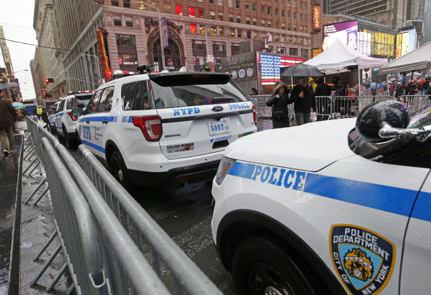 A line of police cars are parked along a street in Times Square, Thursday, Dec. 29, 2016, in New York. Police say they are up to the task of protecting the huge crowds that will gather in and around Times Square for New York City's massive New Year's Eve celebration. (AP Photo/Kathy Willens)