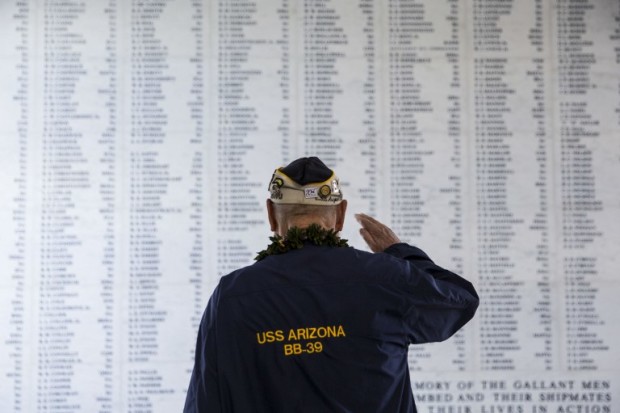 PEARL HARBOR, HAWAII - DECEMBER 07: U.S.S. Arizona survivor Louis Conter salutes the remembrance wall of the U.S.S. Arizona during a memorial service for the 73rd anniversary of the attack on the U.S. naval base at Pearl harbor on December 07, 2014 in Pearl Harbor, Hawaii. On the morning of December 7, 1941 a surprise military attack was conducted by aircraft of the Imperial Japanese Navy against the U.S. Pacific Fleet being moored in Pearl Harbor, marking the entry of the U.S. in World War II. More than 2,400 people were killed and thousands wounded, with dozens of Navy vessels either sunk or destroyed.   Kent Nishimura/Getty Images/AFP