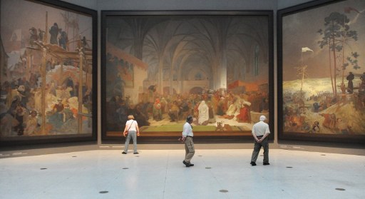 Visitors look at paintings of the "Slav Epic", a cycle of 20 allegories tracing the history of the Slavic people and inspired in part by mythology, by Art Nouveau Czech artist Alfons Mucha, at the National Gallery in Prague. Photo from AFP. 