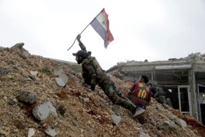 Syrian soldier with flag at frontline