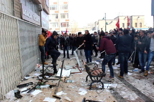 TURKEY OUT This picture obtained from Dogan News Agency shows people protesting in front of the offices of pro-Kurdish Peoples' Democratic Party (HDP) following a suicide car bombing on December 17, 2016 in Kayseri.  Thirteen Turkish soldiers were killed and dozens more wounded on December 17 in a suicide car bombing targeting off-duty conscripts blamed on Kurdish militants, the latest in a string of attacks to rock Turkey in recent months. Forty-eight soldiers were wounded in the attack which struck when the soldiers were being taken from their barracks by bus on a weekend shopping trip, the army said in a statement. The government said all signs so far suggested the the outlawed Kurdistan Workers Party (PKK) was behind the bombing. / AFP PHOTO / DOGAN NEWS AGENCY / - / Turkey OUT