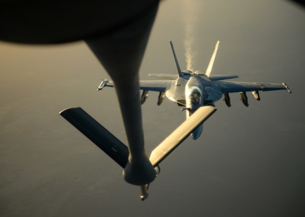 This US Air Forces Central Command photo released by the Defense Video & Imagery Distribution System (DVIDS) shows a US Navy F-18E Super Hornet approaching to receive fuel from a KC-135 Stratotanker over northern Iraq after conducting air strikes in Syria, September 23, 2014.  These aircraft were part of a large coalition strike package that was the first to strike ISIL targets in Syria.    AFP PHOTO / US Air Force / Staff Sgt. Shawn Nickel    == RESTRICTED TO EDITORIAL  USE / MANDATORY CREDIT:  "AFP PHOTO / US Air Forces Central Command via DVIDS /  Staff Sgt. Shawn Nickel" /  NO SALES / NO MARKETING / NO ADVERTISING CAMPAIGNS / DISTRIBUTED AS A SERVICE TO CLIENTS == / AFP PHOTO / US Air Forces Central Command / Staff Sgt. Shawn Nickel