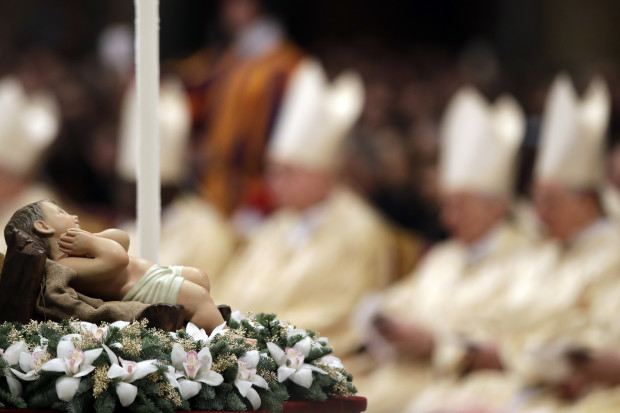 A statue of Baby Jesus is displayed during the Christmas Eve Mass celebrated in St. Peter's Basilica by Pope Francis at the Vatican, Saturday, Dec. 24, 2016. The pontiff urged Christians to celebrate the birth of Jesus by thinking about the plight of today's children, bemoaning how they're forced to hide to escape bombs or flee in a migrant boat or how they’re prevented from being born entirely. (AP Photo/Alessandra Tarantino)
