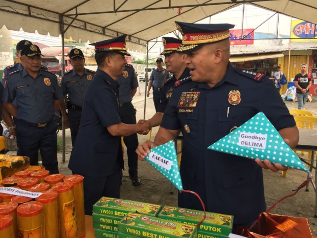 PNP chief Director General Ronald 'Bato' dela Rosa holds two banned firecrackers following an inspection on pyrotechnics stores in Bocaue, Bulacan. One of the seized firecrackers was dubbed 'Goodbye De Lima,' named after Sen. Leila de Lima, who recently figured heavily in the news because of her alleged links to illegal drugs. JOAN BONDOC / PHILIPPINE DAILY INQUIRER