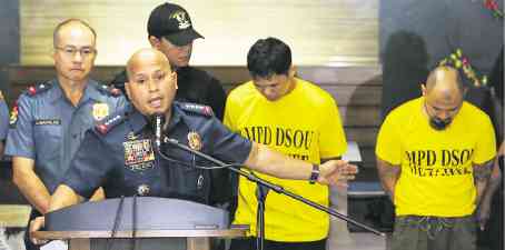 In a Camp Crame briefing on Thursday, Philippine National Police chief Director General Ronald dela Rosa presents Jiaher Kali Guinar and Rayson Sacdal Kilala who were arrested for allegedly planting a home-made bomb found near the US Embassy on Nov. 28. —LYN RILLON
