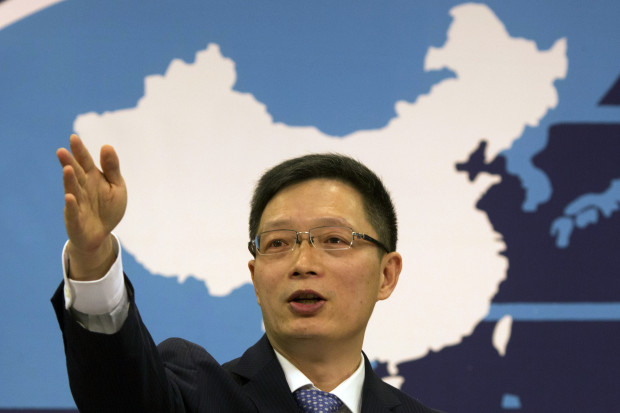 Taiwan Affairs Office spokesman An Fengshan signals for questions from a journalist at a routine press conference in Beijing, China, Wednesday, Dec. 14, 2016. China says any change in U.S. policy favoring formal recognition of Taiwan will "seriously" damage peace and stability in the Taiwan Strait and undermine relations between Beijing and Washington. (AP Photo/Ng Han Guan)