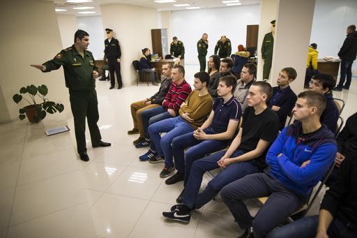 In this photo taken on Friday, Oct. 28, 2016, a Russian military officer, left, speaks to candidates for recruitment at the military's recruitment center in Yekaterinburg, Russia. Increasingly, the young men of Russia say they see military service as an opportunity, not a dreaded obligation to avoid. AP 