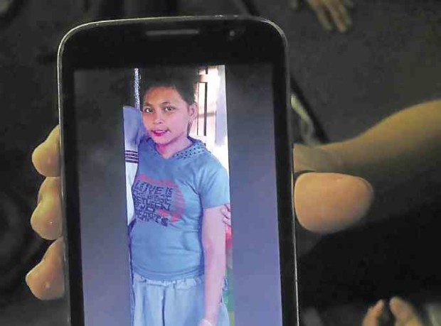 Twelve-year-old Kristine Joy Sailog, shown in her mobile phone, is the latest collateral damage in the war on drugs. —CLIFFORD NUNEZ/CONTRIBUTOR