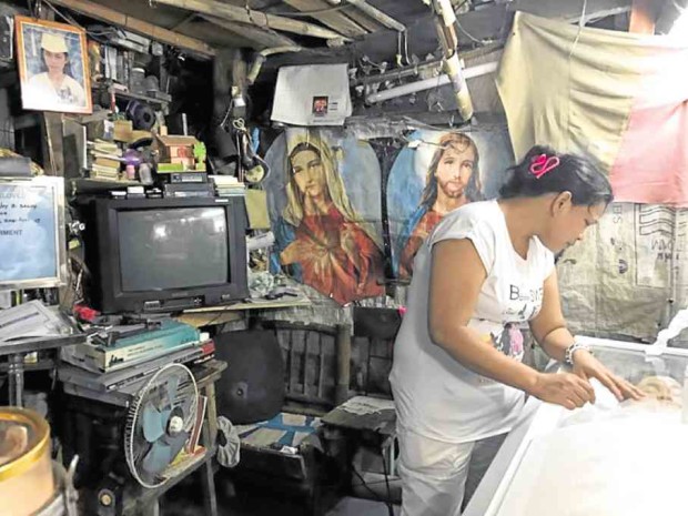 Kimberly Sailog seems to be alone in mourning her daughter, Kristine Joy, whose coffin occupies nearly the whole first floor of the Sailog house, actually a shack, in the village of San Antonio, Biñan City. —CLIFFORD NUNEZ/CONTRIBUTOR
