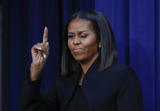 First lady Michelle Obama 'winks' and gestures to guests after after speaking following the screening for the movie 'Hidden Figures,' Thursday, Dec. 15, 2016, in the South Court Auditorium in the Eisenhower Executive Office Building on the White House complex in Washington. AP