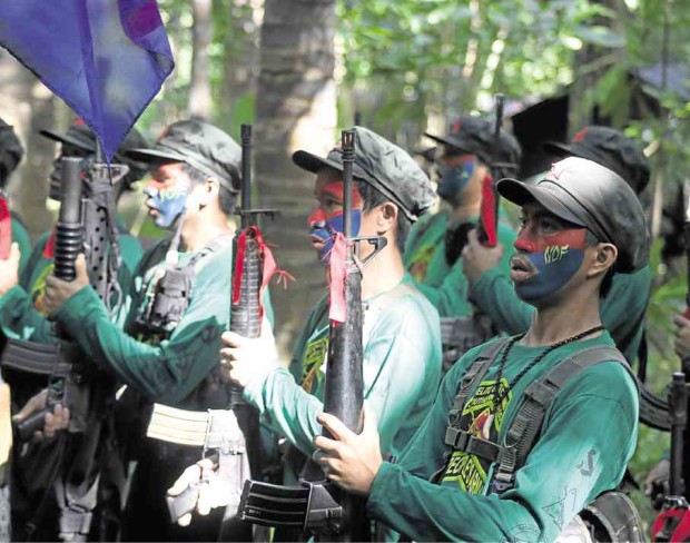 New People’s Army guerrillas stand in formation in a guerrilla camp somewhere in the Sierra Madre mountain range after a clandestine press conference in November. —CONTRIBUTED PHOTO