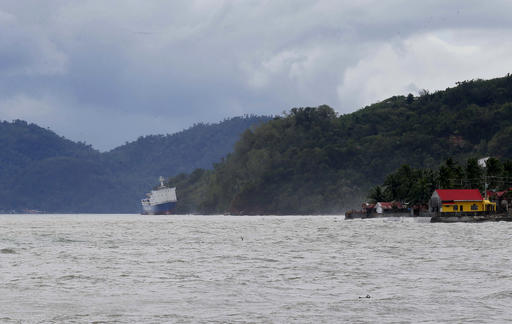 The passenger ferry Shuttle Roro 5 is shown resting by shoreline after being swept by typhoon Nock-Ten, a day after Christmas Monday, Dec. 26, 2016 at Mabini township, Batangas province, south of Manila, Philippines. The powerful typhoon slammed into the eastern Philippines on Christmas Day, spoiling the biggest holiday in Asia's largest Catholic nation but weakened slightly on Monday as it roared toward a congested region near the country's capital, officials said. (AP Photo/Bullit Marquez)