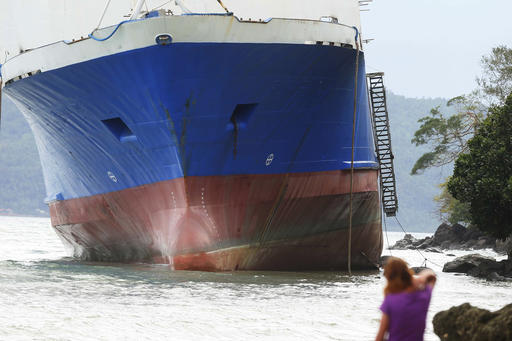The passenger ferry Shuttle Roro 5 is shown resting by shoreline after being swept by typhoon Nock-Ten a day after Christmas Monday, Dec. 26, 2016 at Mabini township, Batangas province, south of Manila, Philippines. The powerful typhoon slammed into the eastern Philippines on Christmas Day, spoiling the biggest holiday in Asia's largest Catholic nation but weakened slightly on Monday as it roared toward a congested region near the country's capital, officials said. (AP Photo/Bullit Marquez)