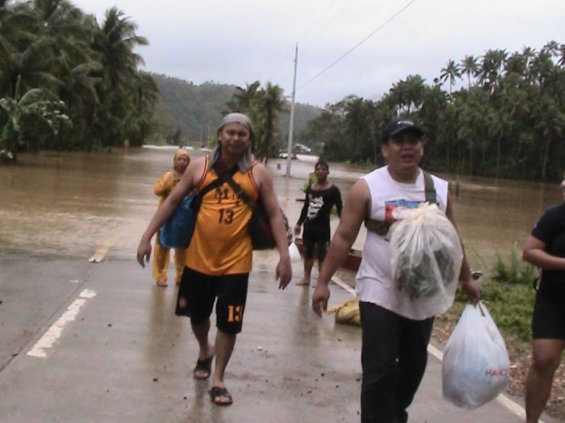 People force themselves to walk on the highway in Eastern Samar after floods rendered the roads impassable. ROBERT DEJON