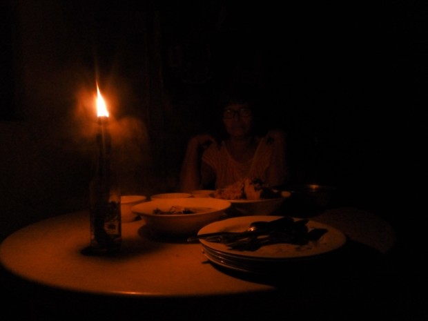 A family is waiting for dinner by kerosene lamp due to a power cut. Leo Udtohan/INQUIRER PHOTO