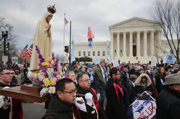 WASHINGTON, DC - JANUARY 27: Members of The American Society for the Defense of Tradition, Family and Property, carry a statue of the Virgin Mary in front of the U.S. Supreme Court building during the 43rd annual March for Life January 27, 2017 in Washington, DC. The march is a gathering and protest against the United States Supreme Court's 1973 Roe v. Wade decision legalizing abortion.   Chip Somodevilla/Getty Images/AFP
