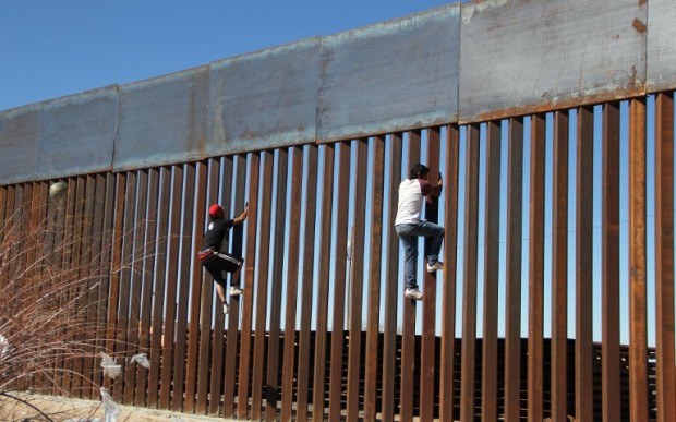 Boys play around, climbing the border division between Mexico and the US in Ciudad Juarez, Mexico on January 26, 2017.  US President Donald Trump on Thursday told Mexico's president to cancel an upcoming visit to Washington if he is unwilling to foot the bill for a border wall. Escalating a cross border war of words, Trump took to Twitter to publicly upbraid Enrique Pena Nieto. "If Mexico is unwilling to pay for the badly needed wall, then it would be better to cancel the upcoming meeting." / AFP PHOTO / HERIKA MARTINEZ