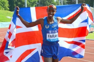 Mo Farah holds British flag behind him