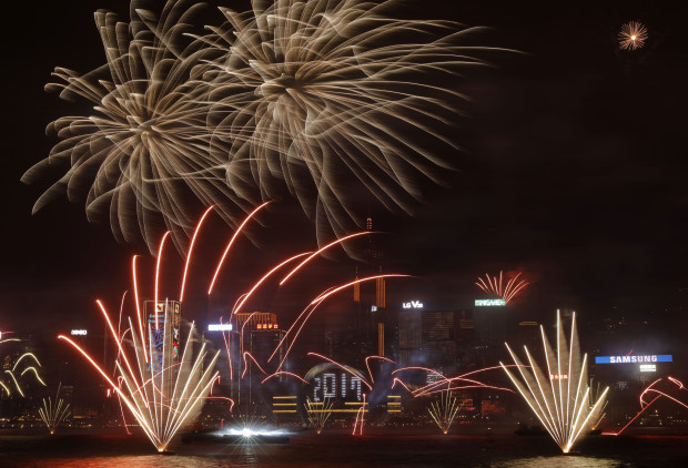 Fireworks explode over Victoria Harbour to celebrate the New Year's Eve in Hong Kong, early Sunday, Jan. 1, 2017. (AP Photo/Vincent Yu)