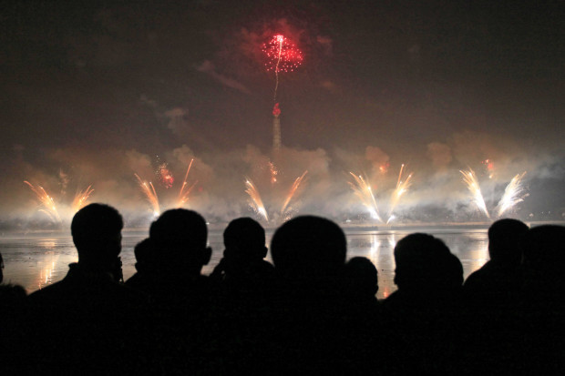 North Koreans gather to watch a New Year's fireworks display at the Kim Il Sung Square in Pyongyang, North Korea, on Sunday, Jan. 1, 2017. (AP Photo/Kim Kwang Hyon)
