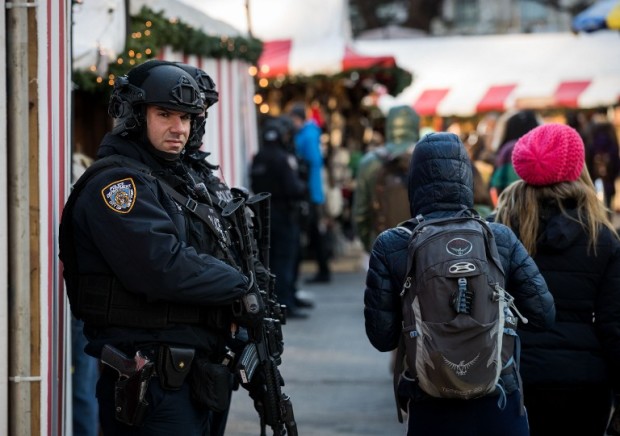 NEW YORK, NY - DECEMBER 20: Heavily armed New York City Police officers stand guard at the Columbus Circle Holiday Market, December 20, 2016 in New York City. Following the fatal truck incident at a holiday market in Berlin, New York City Police has increased security at outdoor Christmas markets throughout the city.   Drew Angerer/Getty Images/AFP