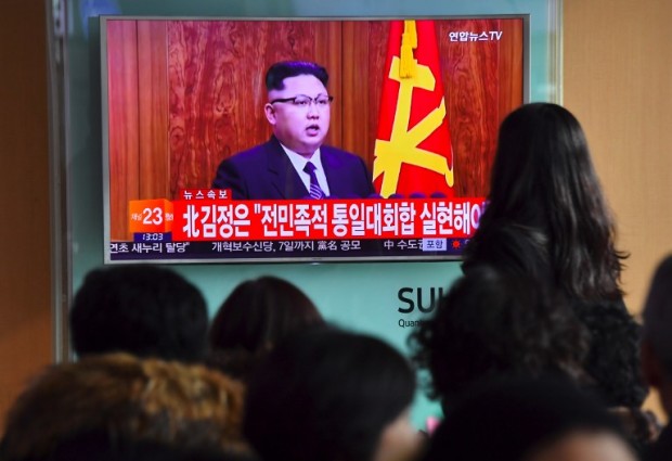People watch a television news broadcast at a railway station in Seoul on January 1, 2017 showing North Korean leader Kim Jong-Un's New Year's speech. North Korea is in the "final stages" of developing an intercontinental ballistic missile, leader Kim Jong-Un said on January 1, claiming the country had significantly bolstered its nuclear deterrent. / AFP PHOTO / JUNG Yeon-Je