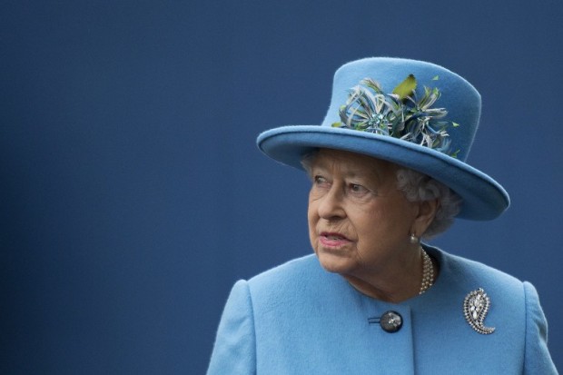 (FILES) This file photo taken on October 27, 2016 shows  Britain's Queen Elizabeth II is photographed on a visit to the town of Poundbury, southwest England. Queen Elizabeth II will not attend a New Year's Day church service on January 1, 2017, because of a lingering "heavy cold" that also forced her to stay at home on Christmas Day, Buckingham Palace said Sunday. The 90-year-old monarch, who is the supreme governor of the Church of England, will not join other members of the royal family as they attend church in Sandringham in Norfolk, eastern England. / AFP PHOTO / POOL / JUSTIN TALLIS