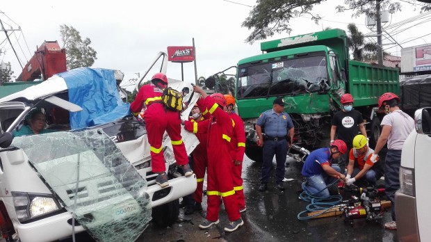 Rescue teams struggle to free the injured from the damaged trucks in a road accident in Quezon Thursday. Contributed photo by Flovic Tariga.