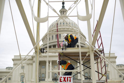 FILE - In this Dec. 8, 2016 file photo, construction continues on the Inaugural platform in preparation for the Inauguration and swearing-in ceremonies for President-elect Donald Trump, on the Capitol steps in Washington. Trump’s Presidential Inaugural Committee has raised a record $90 million-plus in private donations, far more than President Barack Obama’s two inaugural committees. They collected $55 million in 2009 and $43 million in 2013, and had some left over on the first go-round. But while Trump has raised more money for his inauguration than any president in history, he’s aiming to do less with it.  (AP Photo/Pablo Martinez Monsivais, File)