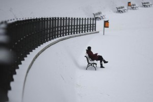 Woman sitting on bench in Berlin after heavy snowfall - 9 Jan 2017