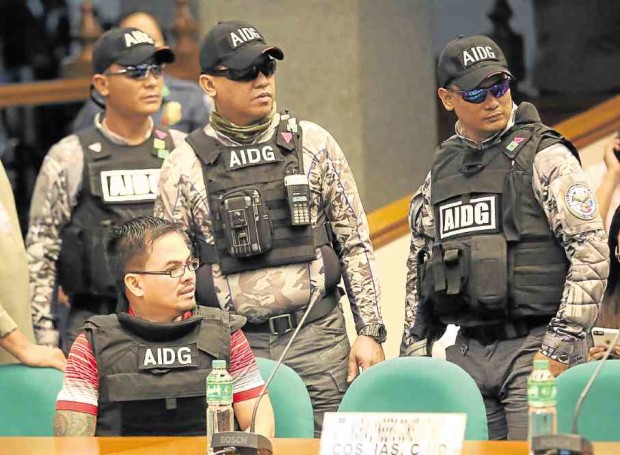 Kerwin Espinosa under heavy guard during his appearance at the Senate on Dec. 5 last year —MARIANNE BERMUDEZ