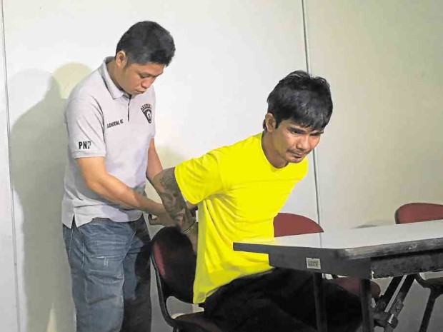 Following his arrest at the Batangas port, Randy Lizardo (right) has admitted shooting at the officers who were alerted to the drug session taking place at his shanty in Pasay City on Jan. 4. -- Dexter Cabalza 