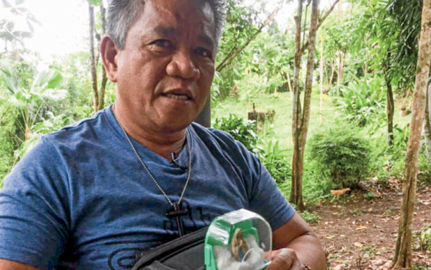 DIVINE GUIDANCE? Edgar Matobato holds an image of the Virgin Mary while being interviewed at his safe house by an Inquirer.net team about his killing missions. —KRISTINE ANGELI SABILLO