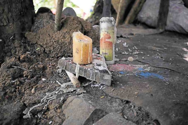 Candles mark the spot where Marcelo Daa Jr. was shot dead in an antidrug operation by the Quezon City police on Aug. 21, 2016. 