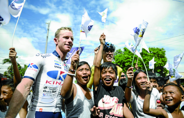 Australia's Jai Crawford of Kinan Cycling Team, the winner of Le Tour de Filipinas 8th Edition and Great Britain's Daniel Whitehouse of Terengannu Cycling Team is all smiles with some fans after finishing the stage four, a 207KM from Daet to Lucena.  INQUIRER PHOTO/ Sherwin Vardeleon