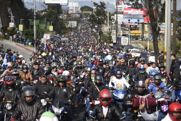 Bikers set out in a convoy from Constitution Square in Guatemala City to Esquipulas, 222 km to the east, to visit a 16th-century carved black statue of Jesus in a basilica, on February 4, 2017. Some 30,000 motorcycle-riding Catholics left the Guatemalan capital Saturday on a pilgrimage to the eastern city of Esquipulas to venerate the so-called Black Christ. / AFP PHOTO / JOHAN ORDONEZ