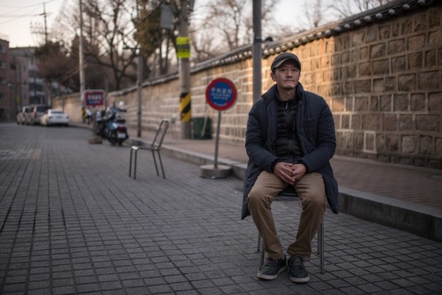 This photo taken on February 8, 2017 shows film distributor Kim Il-Kwon posing for a photo on a street outside his office in Seoul. Kim was one of thousands of artists secretly blacklisted by the conservative government for voicing "left-wing" thoughts -- meaning criticism of the authorities. The government blacklist was aimed at starving artists of official subsidies and private funding and placing them under state surveillance, according to prosecutors probing the sprawling South Korean corruption and power abuse scandal that has brought millions of people onto the streets and seen President Park Geun-Hye impeached. Photo from AFP.