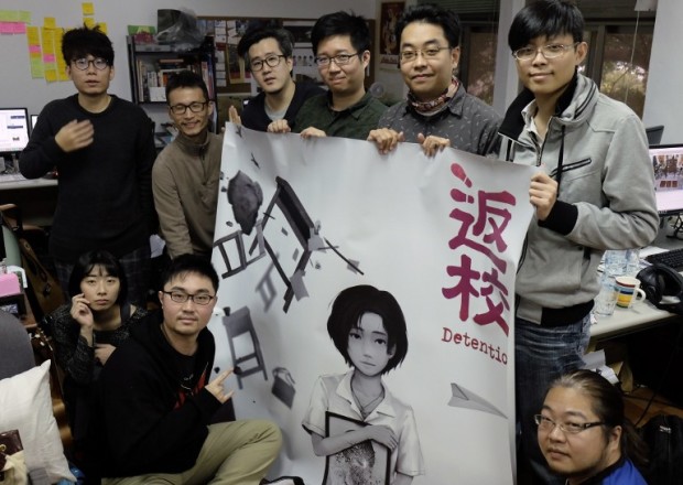 This picture taken on February 16, 2017 shows Yao Shuen-ting (top 2nd R), a co-founder of game developer Red Candle Games, and his colleagues displaying a poster of the video game "Detention" during an interview in Taipei. As the 70th anniversary of a bloody political purge in Taiwan looms, a new horror video game set during the island's "White Terror" is winning rave reviews. Photo from AFP.