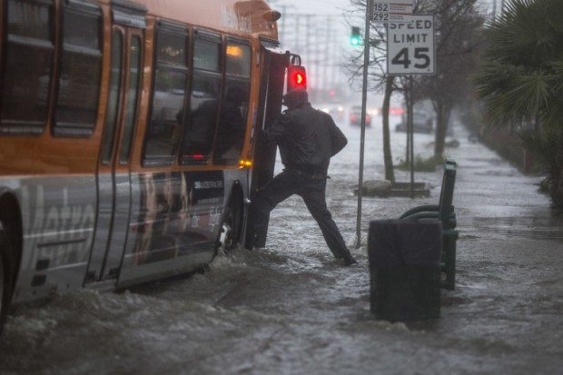 SUN VALLEY, CA - FEBRUARY 17: A man boards a bus on a flooded street as a powerful storm moves across Southern California on February 17, 2017 near Sun Valley, California. After years of severe drought, heavy winter rains have come to the state, and with them, the issuance of flash flood watches in Santa Barbara, Ventura and Los Angeles counties, and the evacuation of hundreds of residents from Duarte, California for fear of flash flooding from areas denuded by a wildfire last year.   David McNew/Getty Images/AFP