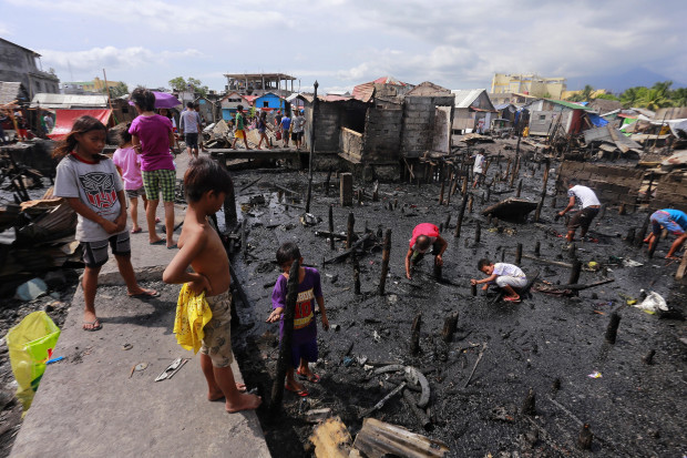 Residents of Victory Village in Legazpi City, view what was left of their community, which was destroyed by fire on Feb. 9, 2017. (PHOTO BY MARK ALVIC ESPLANA / INQUIRER SOUTHERN LUZON)