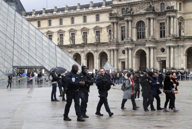 Police officers patrol in front of the Louvre Pyramid in Paris on February 4, 2017 a day after a machete-wielding attacker lunged at four French soldiers while shouting "Allahu Akbar" ("God is greatest") in a public area that leads to one of the Louvre Museum's entrances. The condition of a man who was shot after attacking troops at the Louvre in Paris has improved and is "no longer life-threatening", a source close to the case said on February 4, 2017.  But the man has not recovered sufficiently to be able to communicate with investigators, the source said. / AFP PHOTO / JACQUES DEMARTHON