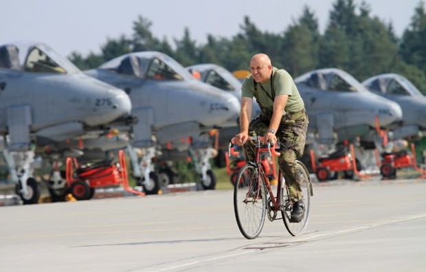 A soldier rides past Air Force A-10 Thunderbolt airplanes in the Air Force Base of Namest, near Brno during the Ramstein Rover 2012 military excercise on September 5, 2012. The exercise organized and managed by the Czech Air Force Component Command HQ AC Ramstein is the largest military exercise in Europe this year, with the participation of 16 countries and NATO. AFP PHOTO/ RADEK MICA / AFP PHOTO / RADEK MICA