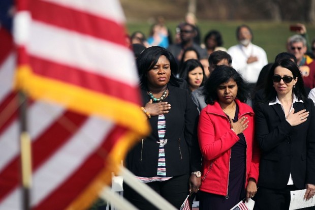 MOUNT VERNON, VA - FEBRUARY 22: New citizens put their hands over the hearts as the Star-Spangled Banner is performed during their natrualization ceremony at George Washington's Mount Vernon February 22, 2017 in Mount Vernon, Virginia. Wednesday marks the 285th anniversary of the birth of George Washington, Revolutionary War general and the first president of the United States of America. Built on land belonging to Washington's family, the Mount Vernon Estate became the sole property of Washington in 1761 and was his country home until his death in 1799.   Chip Somodevilla/Getty Images/AFP