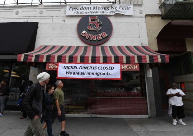 A closed sign at the Nickel Diner restaurant which closed for the day in solidarity with the "Day Without Immigrants" nationwide protests, in Los Angeles, California, on February 16, 2017. From burger joints to posh eateries, scores of restaurants across the nation shut down as part of a protest with echoes across the United States against President Donald Trump's treatment of immigrants.  / AFP PHOTO / Mark RALSTON